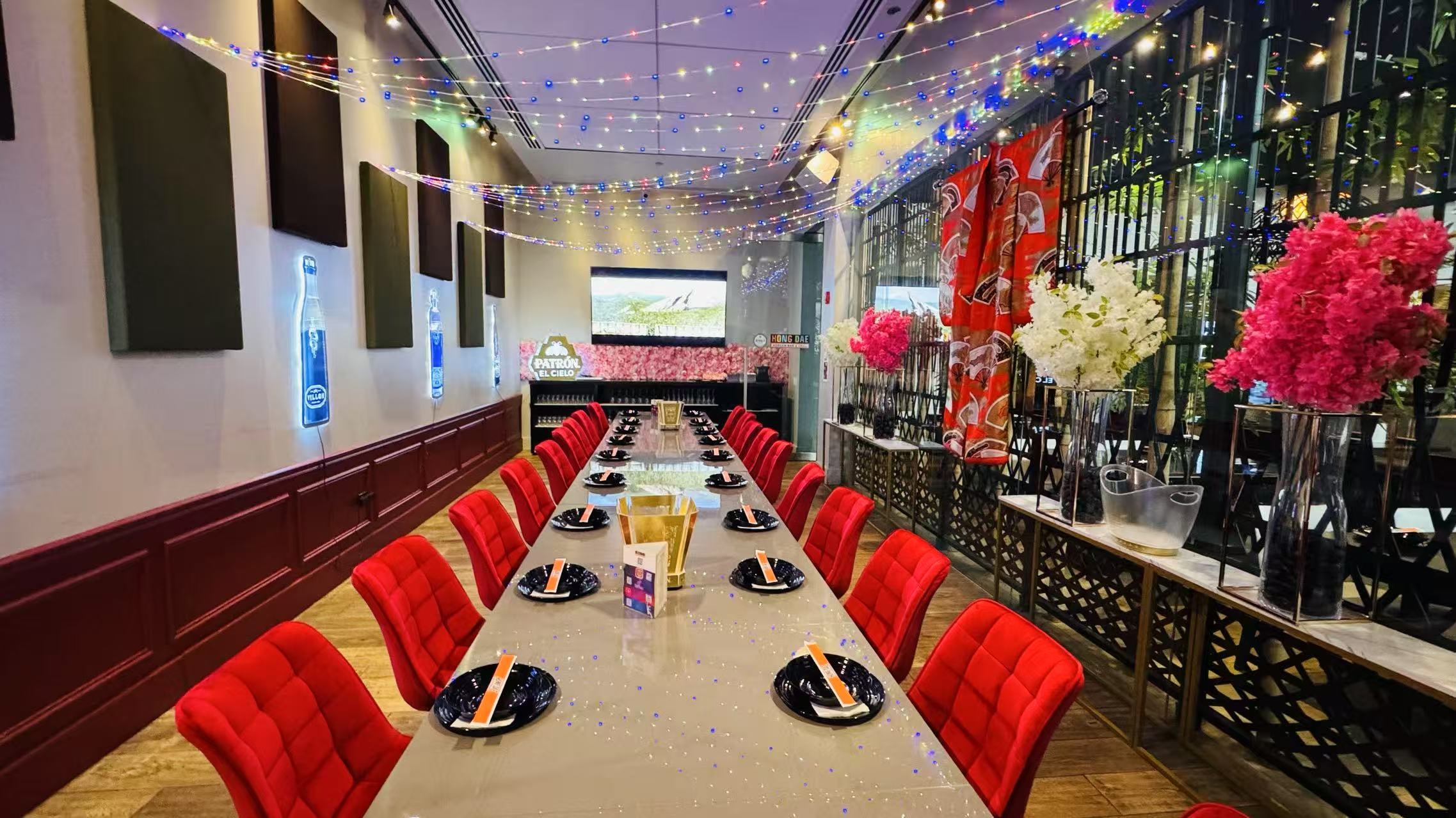 Upscale dining room with red chairs and string lights